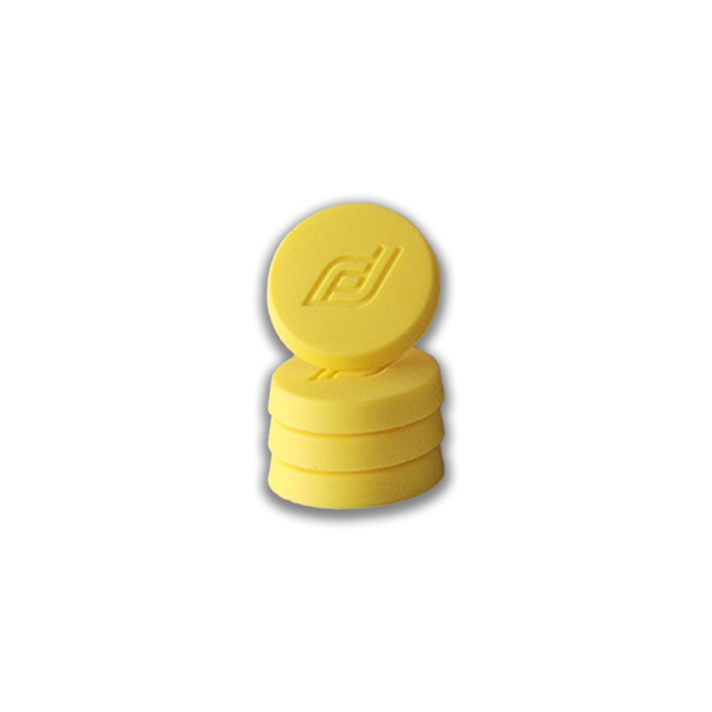 Stack of three yellow round silicone caps with an embossed logo on the top cap